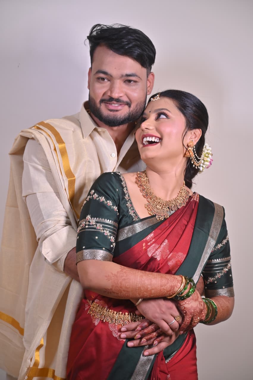 Ravi and Soumya hugging in traditional silk attire