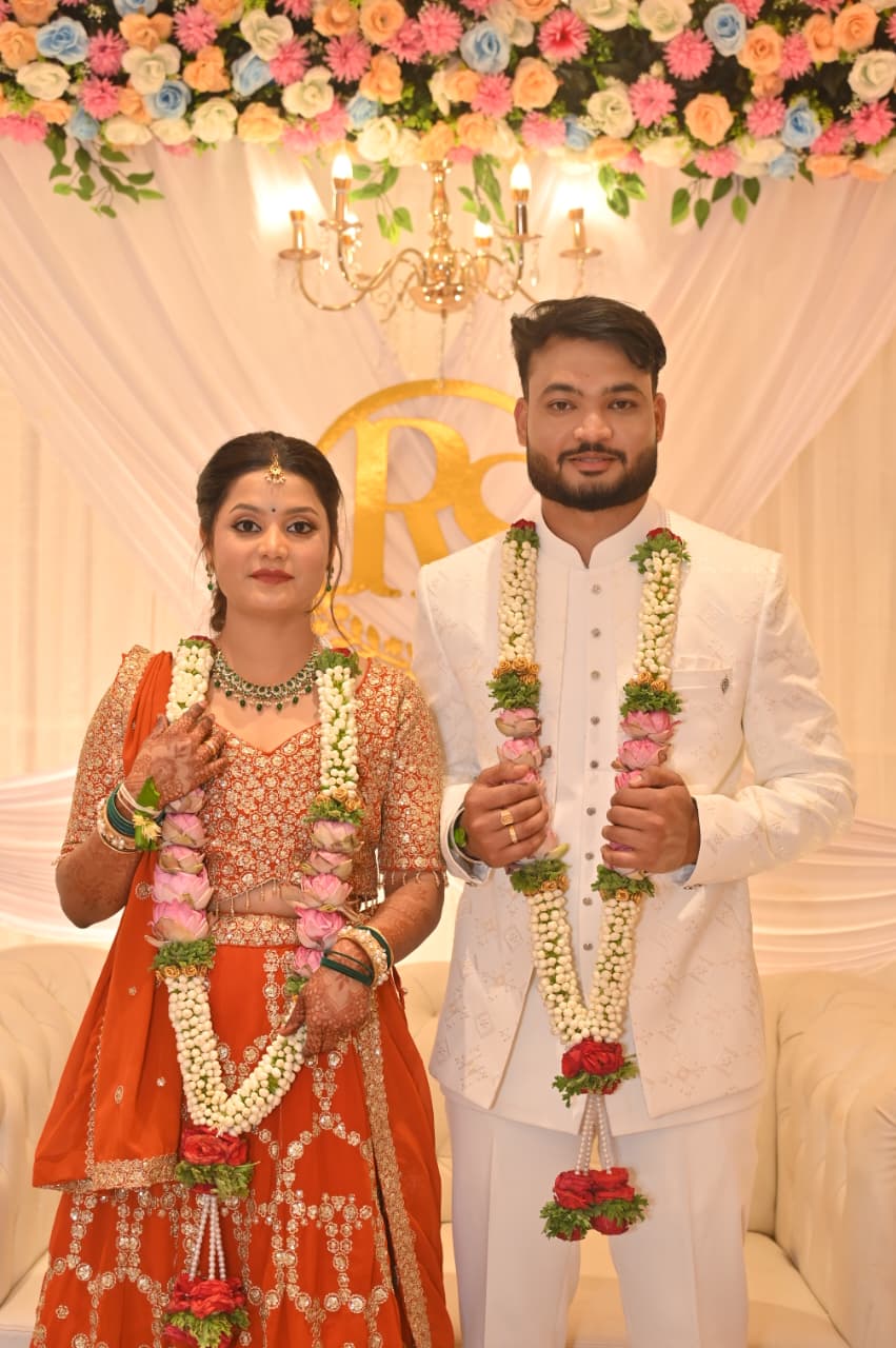 Ravi and Soumya with jasmine garlands on the engagement stage